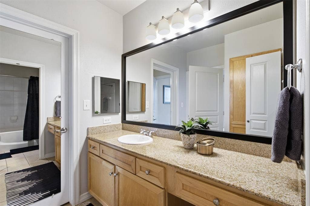 330 Las Colinas Boulevard E, #1216, Irving, TX 75039 Spacious vanity with light-toned cabinetry, light-colored countertop, and a large framed mirror
