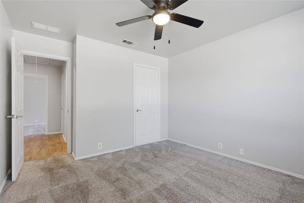 217 Ame Lane, Royse City, TX 75189 Carpeted room with a ceiling fan light fixture, light gray walls, and white trim