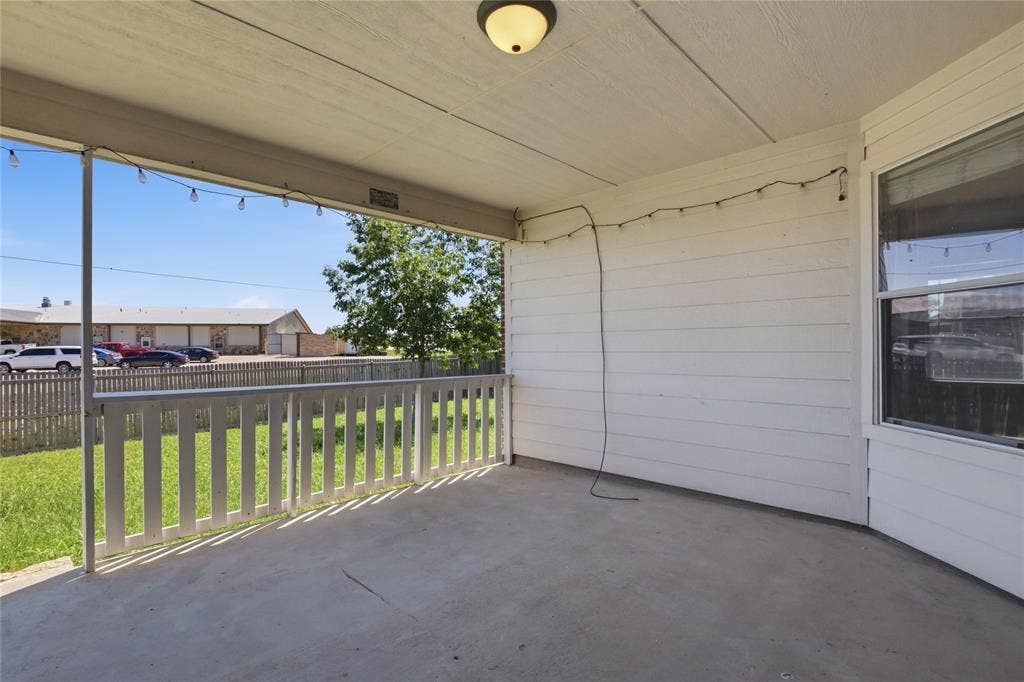 217 Ame Lane, Royse City, TX 75189 Covered patio with a concrete surface, featuring a white railing and exterior siding