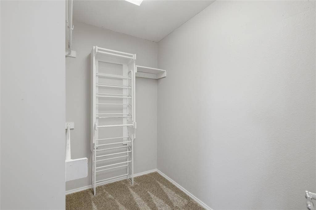 217 Ame Lane, Royse City, TX 75189 Walk-in closet featuring built-in shelving, hanging rods, and carpet flooring