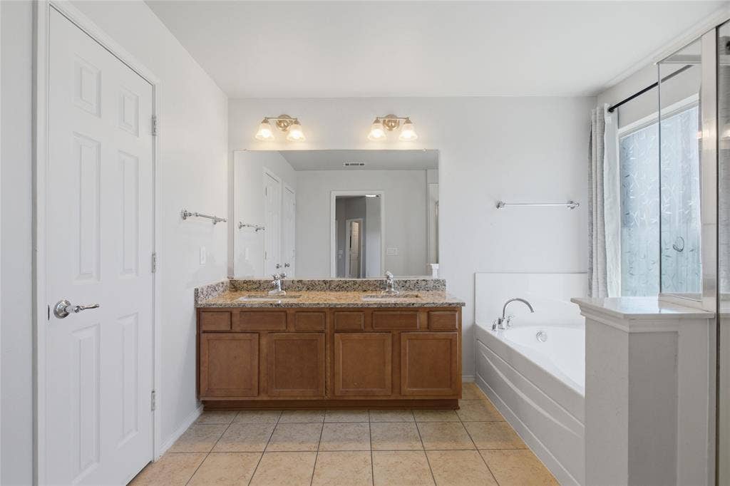 217 Ame Lane, Royse City, TX 75189 Double vanity with granite countertop, integrated sinks, and ample storage cabinetry