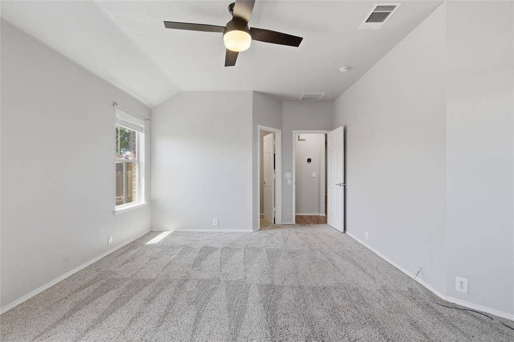 217 Ame Lane, Royse City, TX 75189 Spacious room featuring gray carpeting, a window, and a ceiling fan with integrated lighting