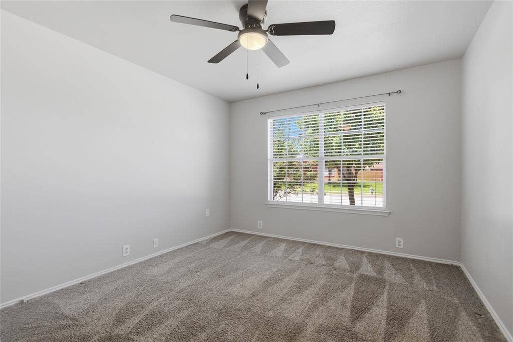 217 Ame Lane, Royse City, TX 75189 Wall-to-wall carpeting, a large window with blinds, and a ceiling fan with integrated lighting