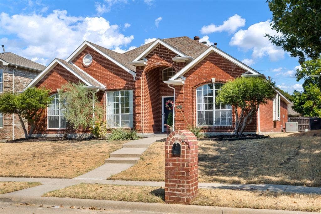 11414 Promenade Road, Frisco, TX 75035 Brick exterior with a gabled roofline, arched entry, and prominent bay windows