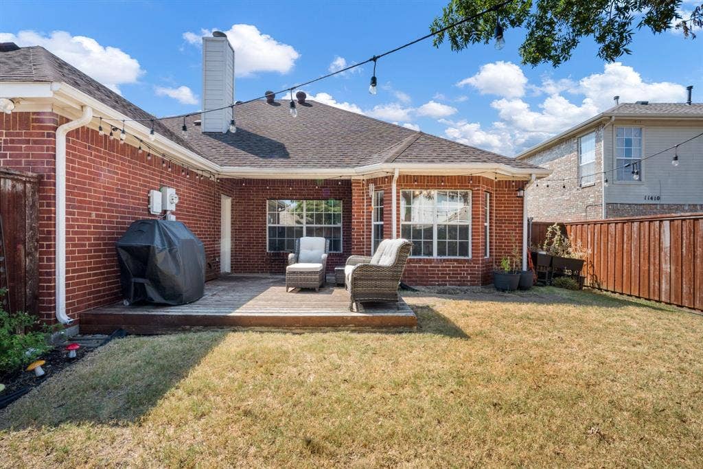11414 Promenade Road, Frisco, TX 75035 Brick exterior with a wooden deck, fenced yard, and multiple windows