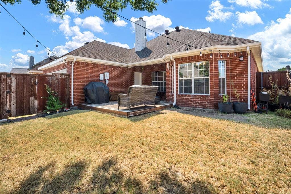 11414 Promenade Road, Frisco, TX 75035 Brick exterior featuring a wooden deck and a private perimeter fence