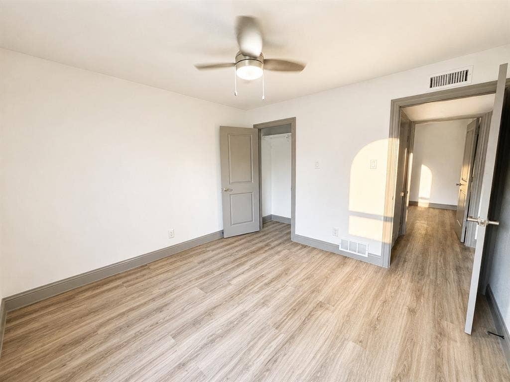 4316 Woodbluff Drive, Mesquite, TX 75150 Wood-finish flooring, neutral wall tones, ceiling fan with integrated lighting, and a closet with bi-fold doors