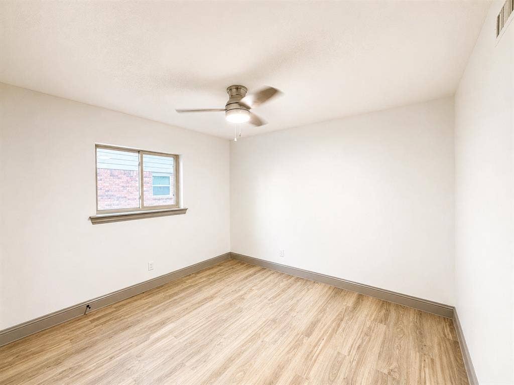 4316 Woodbluff Drive, Mesquite, TX 75150 Wood-finish flooring, ceiling fan with integrated lighting, and a double-pane window