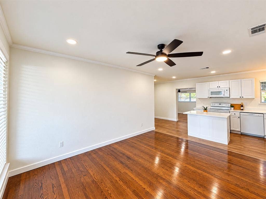 1737 Alta Vista Street, Mesquite, TX 75149 Open floor plan featuring wood-finish flooring, recessed lighting, a modern ceiling fan, and a kitchen equipped with white cabinetry and a center island