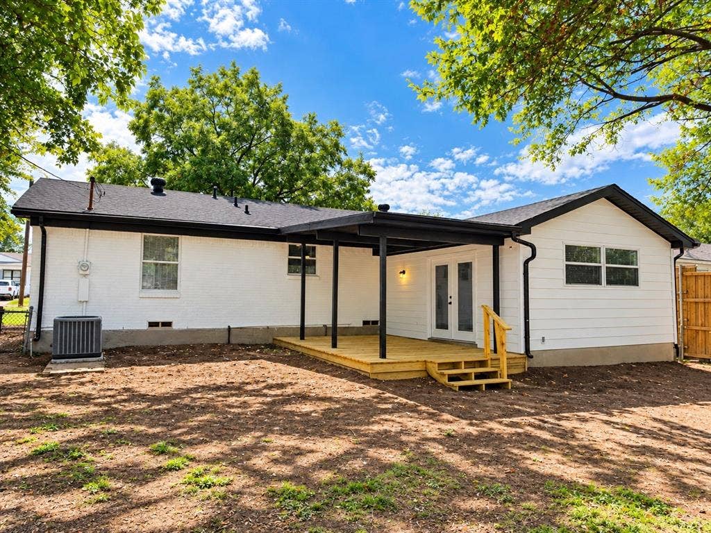 1737 Alta Vista Street, Mesquite, TX 75149 Exterior featuring white-painted brick and horizontal siding, covered wood deck with stairs, and double-door entry