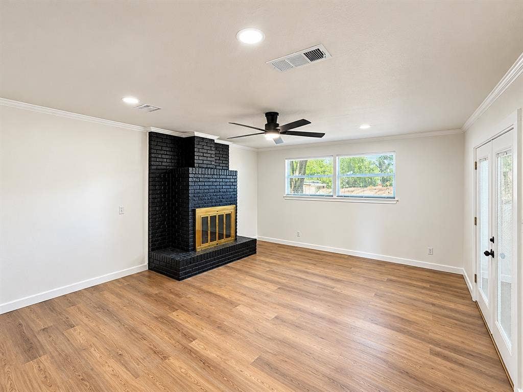 1737 Alta Vista Street, Mesquite, TX 75149 Living area featuring wood-finish flooring, a floor-to-ceiling brick fireplace with a metal screen, recessed lighting, a ceiling fan, and double glass-paned doors