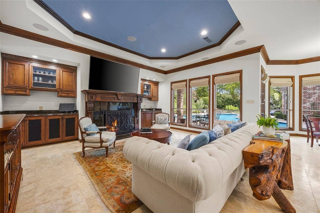 508 Moraine Way, Heath, TX 75032 Inviting family room featuring a beautiful fireplace and custom built-ins.