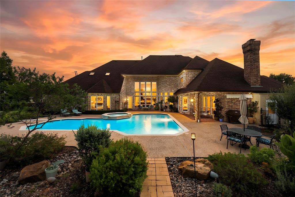 508 Moraine Way, Heath, TX 75032 Expansive landscaped backyard offering privacy, mature trees, and room to enjoy the outdoors.