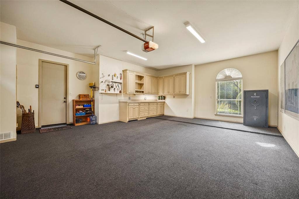 508 Moraine Way, Heath, TX 75032 Spacious garage with custom built-in storage and room for a workshop.