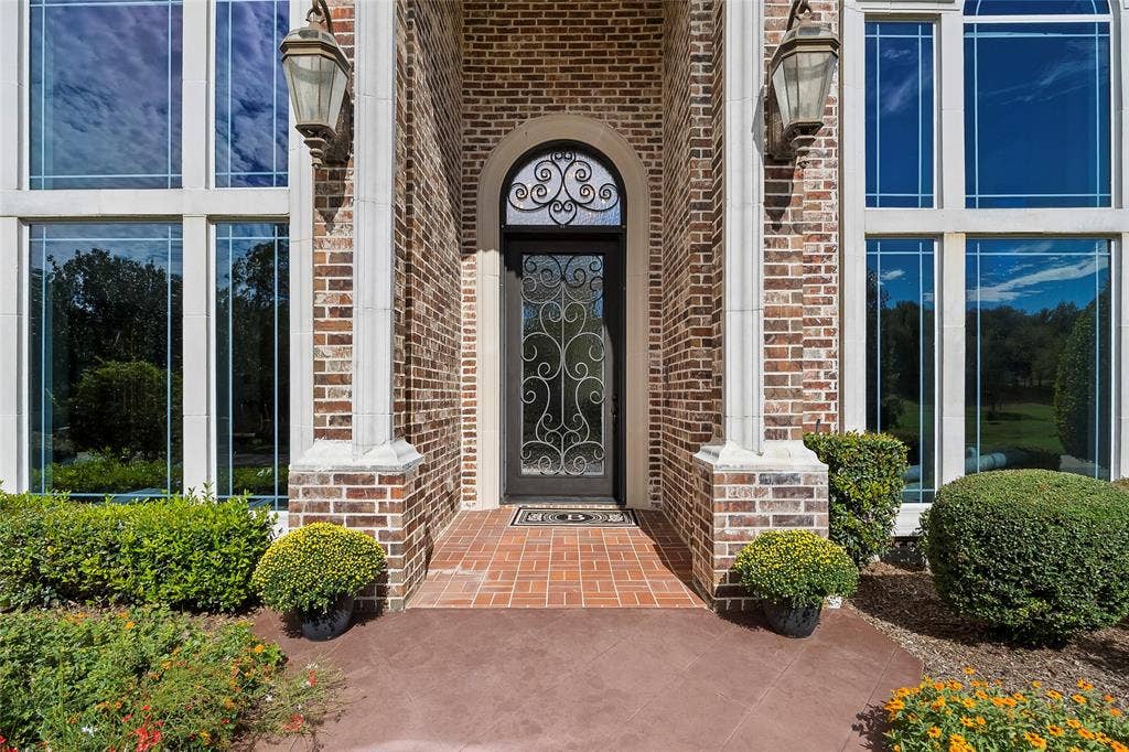 508 Moraine Way, Heath, TX 75032 Inviting entrance showcasing timeless brick architecture and elegant curb appeal.
