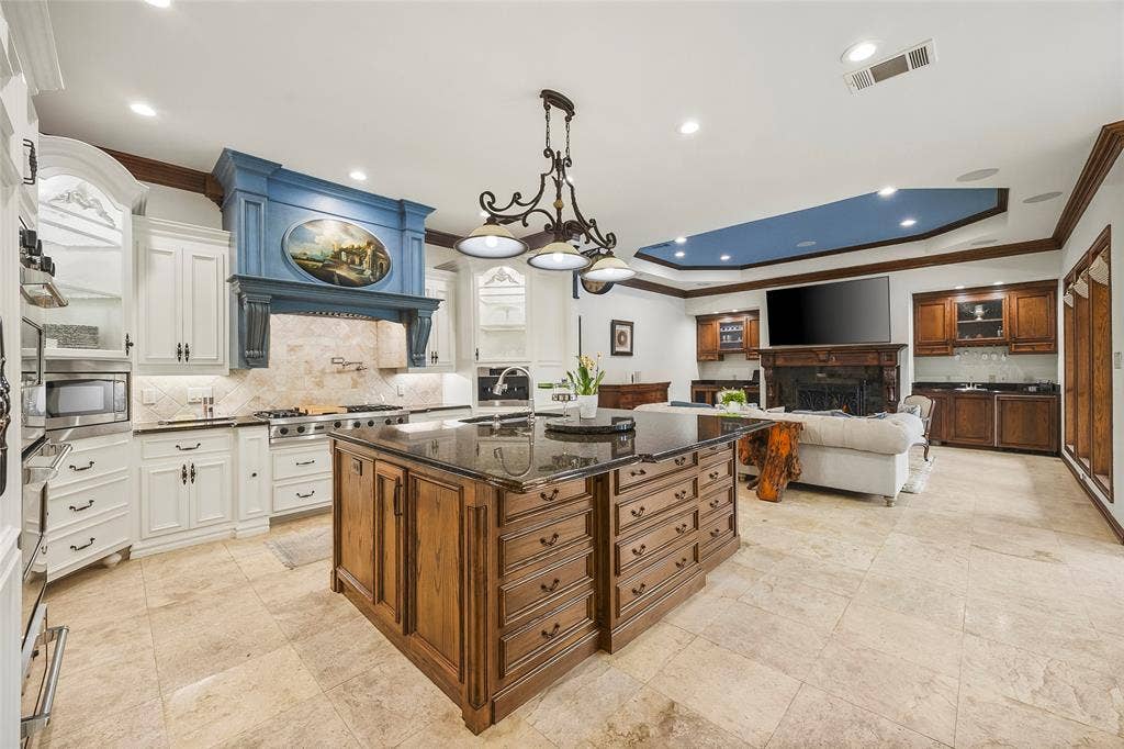 508 Moraine Way, Heath, TX 75032 Gourmet kitchen featuring a large center island, premium appliances, and custom cabinetry.