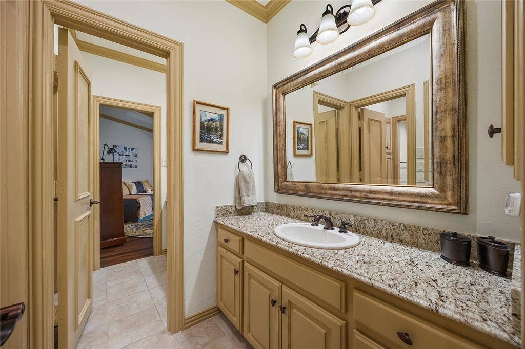 508 Moraine Way, Heath, TX 75032 Elegant bathroom with custom cabinetry, generous counter space, and timeless finishes.