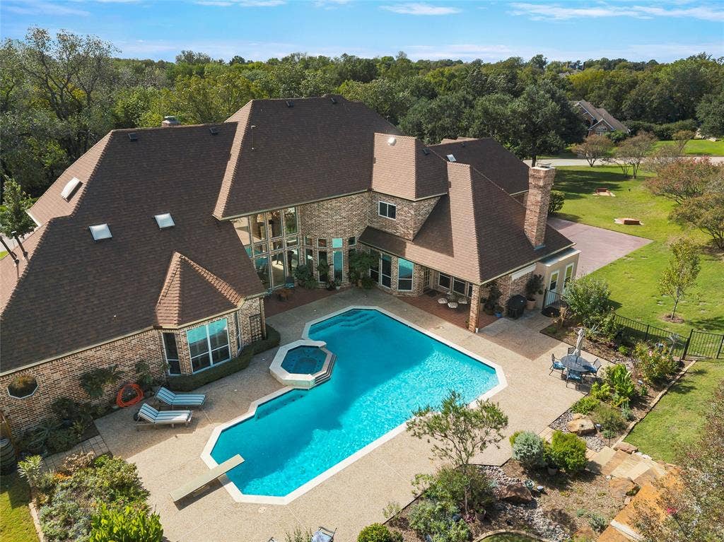508 Moraine Way, Heath, TX 75032 Resort-style backyard featuring a sparkling pool, spa, and outdoor entertaining areas.