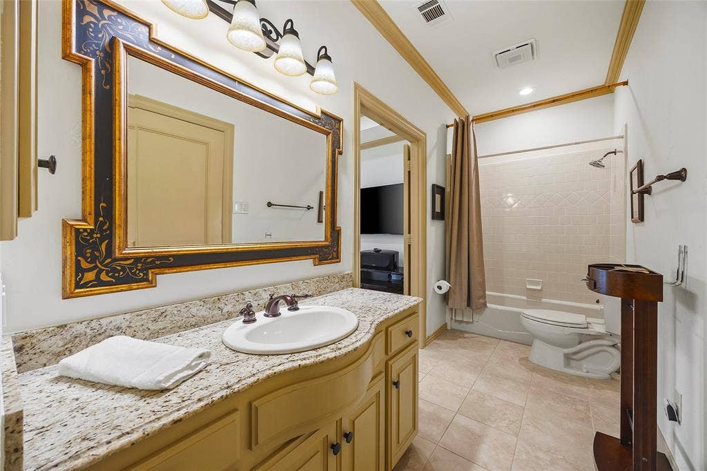 508 Moraine Way, Heath, TX 75032 Well-appointed bathroom with stone countertops and custom cabinetry.