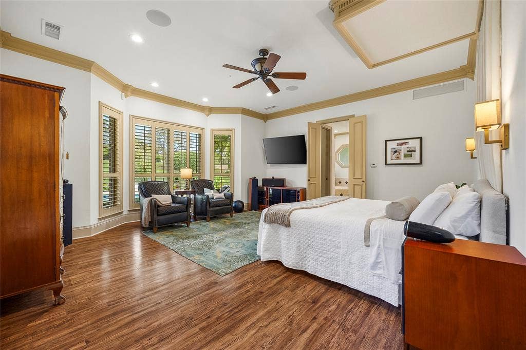 508 Moraine Way, Heath, TX 75032 Spacious bedroom featuring warm wood floors and beautiful natural light.