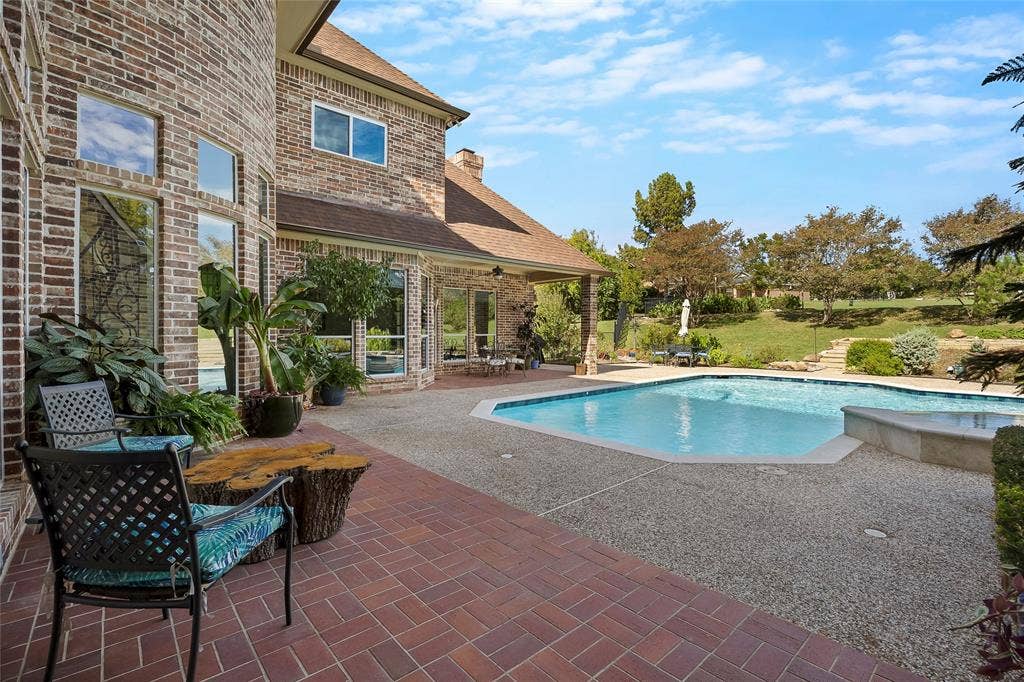 508 Moraine Way, Heath, TX 75032 Tranquil covered outdoor living area overlooking the pool and landscaped backyard.