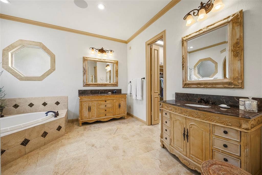 508 Moraine Way, Heath, TX 75032 Beautifully appointed bathroom with dual vanities and custom cabinetry.