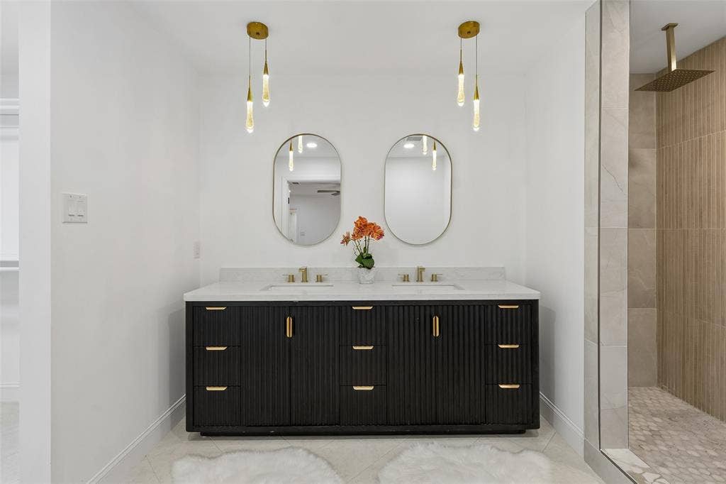 2133 Oak Valley Lane, Dallas, TX 75232 Dual vanity with a white countertop and undermount sinks