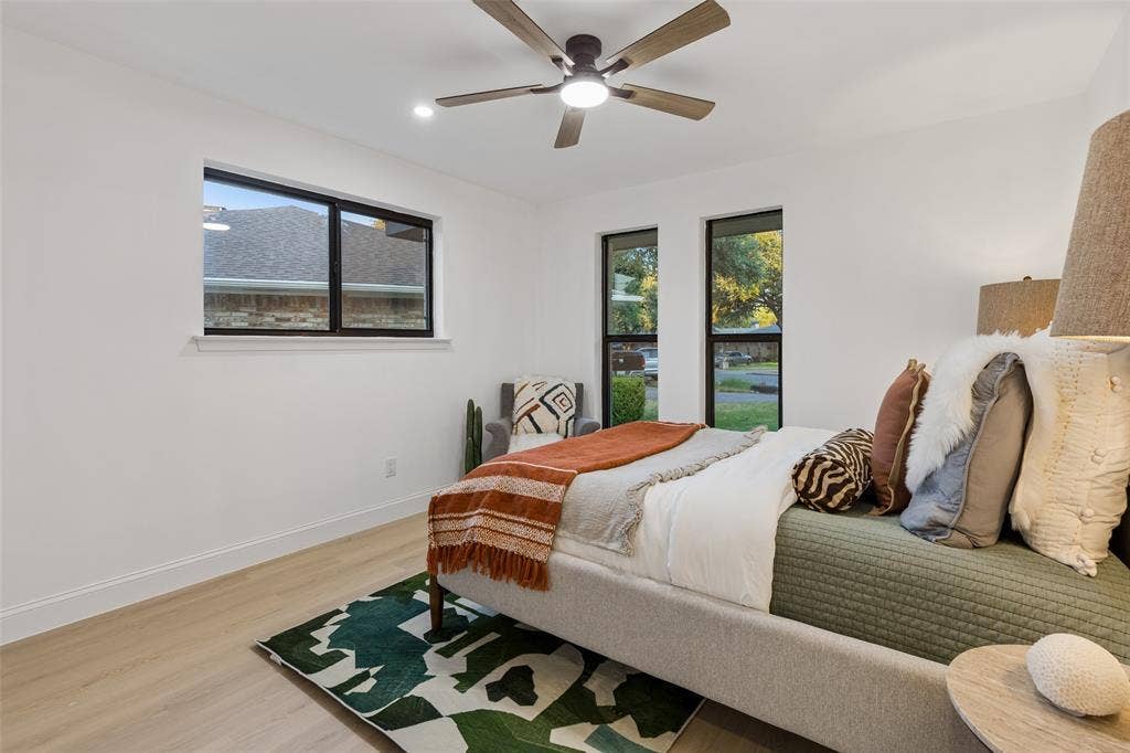 2133 Oak Valley Lane, Dallas, TX 75232 Wood-finish flooring, white walls, and a ceiling fan with integrated lighting