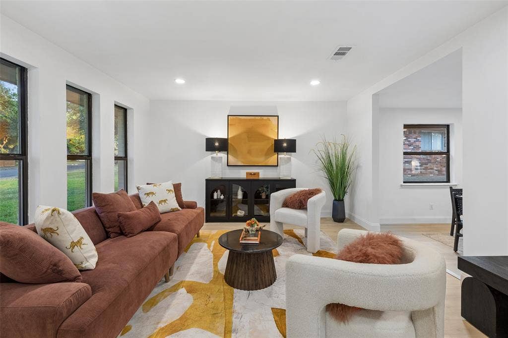 2133 Oak Valley Lane, Dallas, TX 75232 Spacious living area featuring multiple large windows, recessed lighting, and light wood-finish flooring