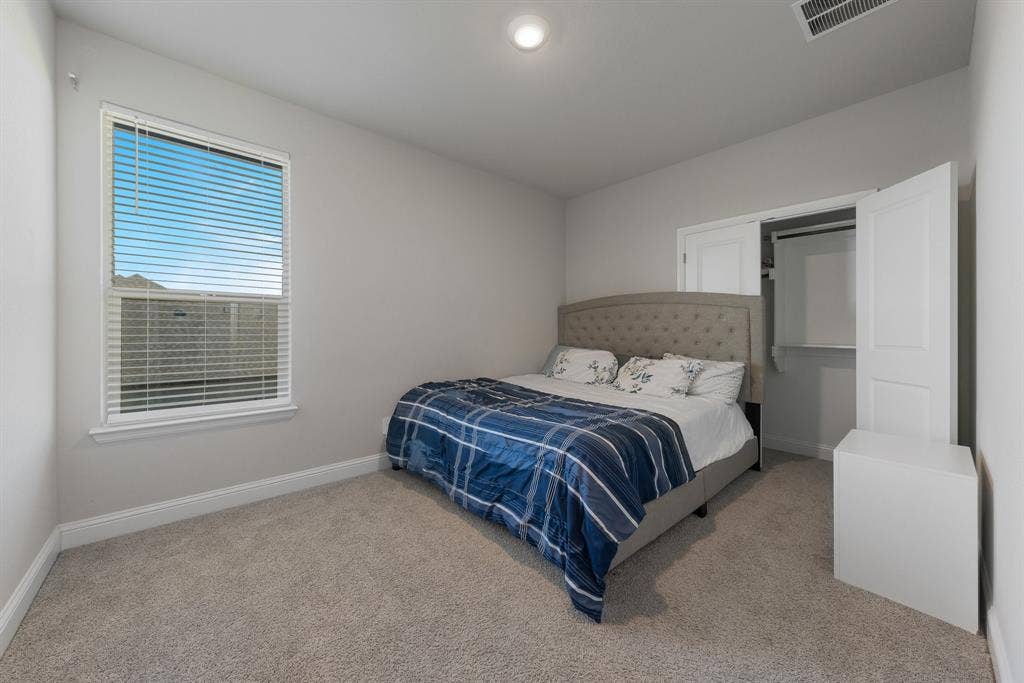Bedroom $4 with baseboards and light carpet