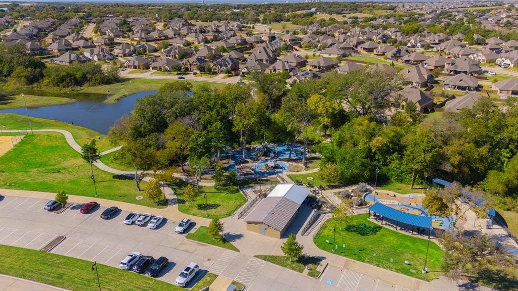 Aerial view of residential area featuring a nearby body of water