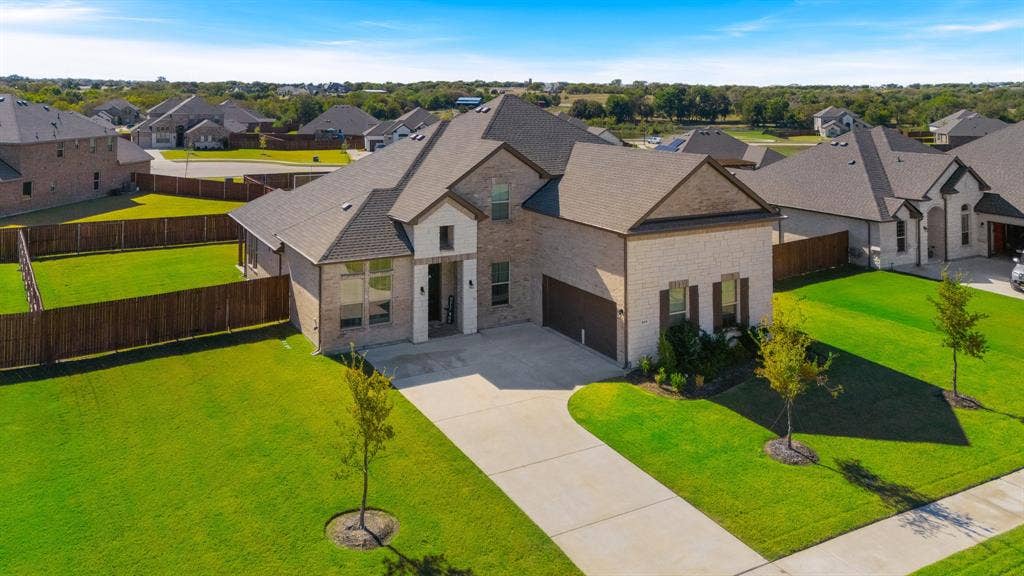 View of front of your home featuring a J-swing driveway, a fenced backyard,
