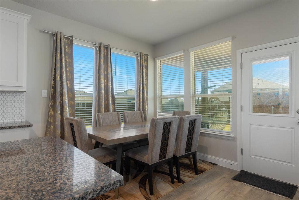 Breakfast nook with light wood-style floors and baseboards