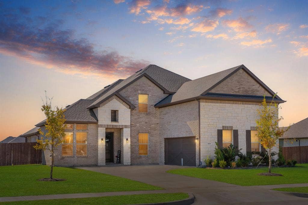 Welcome to 814 Hat Creek. Beautiful brick & stone house, a garage, driveway, and a shingled roof