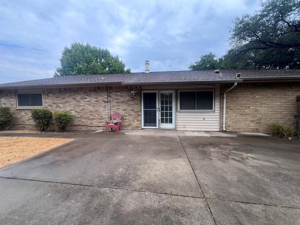 3925 Villa Downs Drive, Plano, TX 75023 Brick exterior featuring multiple windows and a glass-paneled door