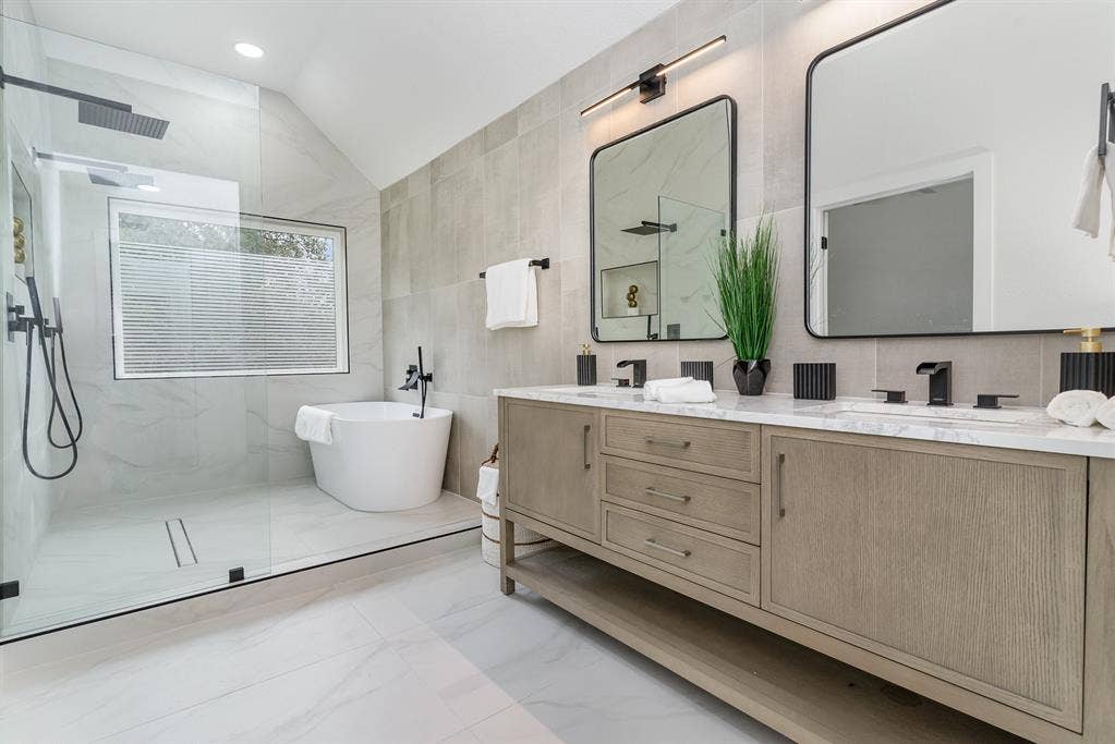 17732 Windflower Way, Dallas, TX 75252 Bathroom with tile walls, vanity, plus walk in shower, and lofted ceiling
