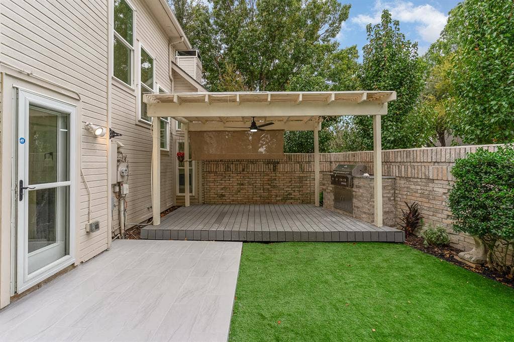 17732 Windflower Way, Dallas, TX 75252 View of yard with ceiling fan and a wooden deck