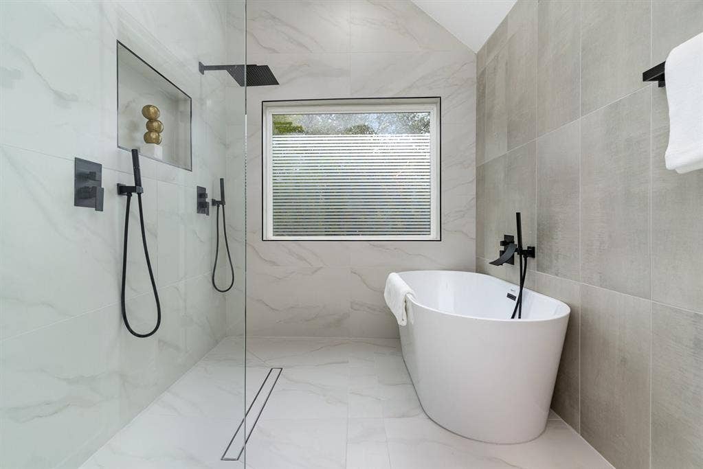 17732 Windflower Way, Dallas, TX 75252 Bathroom with plus walk in shower and tile walls