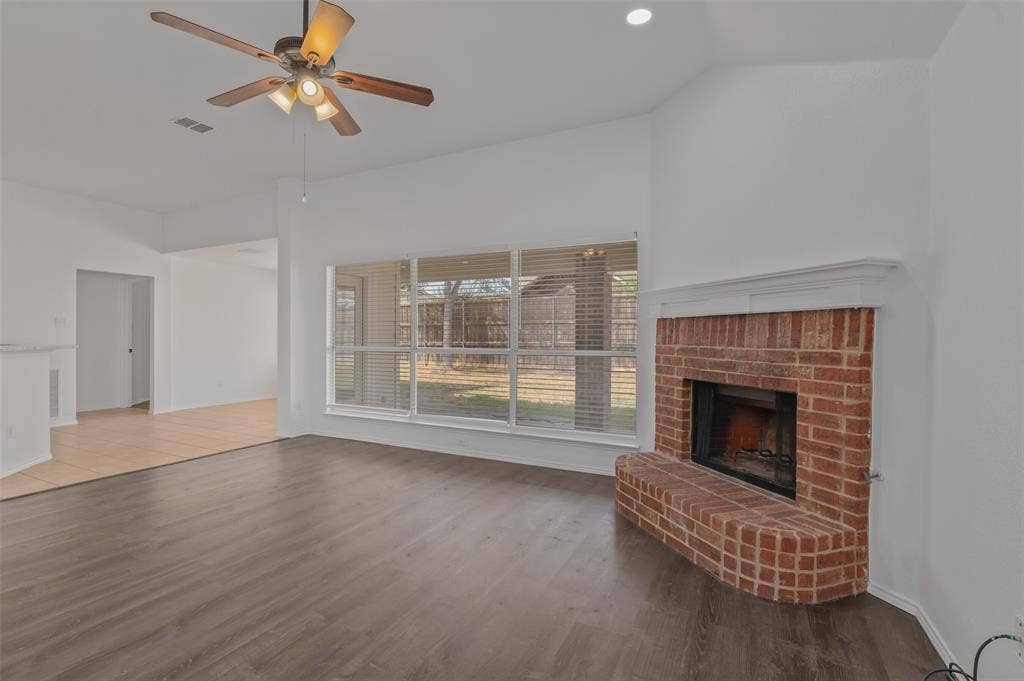 2809 Hollow Ridge Drive, Denton, TX 76210 Living room with wood burning fireplace and view of the covered patio and yard