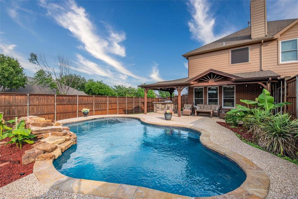 5800 Pine Ridge Boulevard, McKinney, TX 75070 Your backyard space with a pool, covered patio and built-in kitchen.