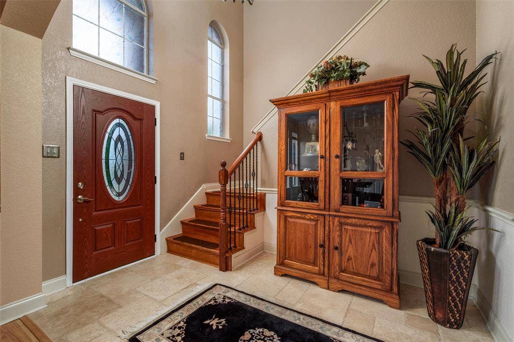 5800 Pine Ridge Boulevard, McKinney, TX 75070 Enter into a foyer with high ceilings and natural light.