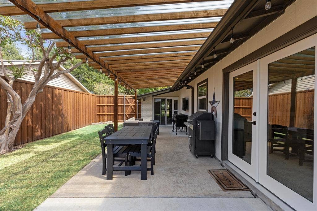 4021 Overdowns Drive, Plano, TX 75023 String lights and an extended, pergola-covered patio turn the backyard into a second living room for Texas evenings.