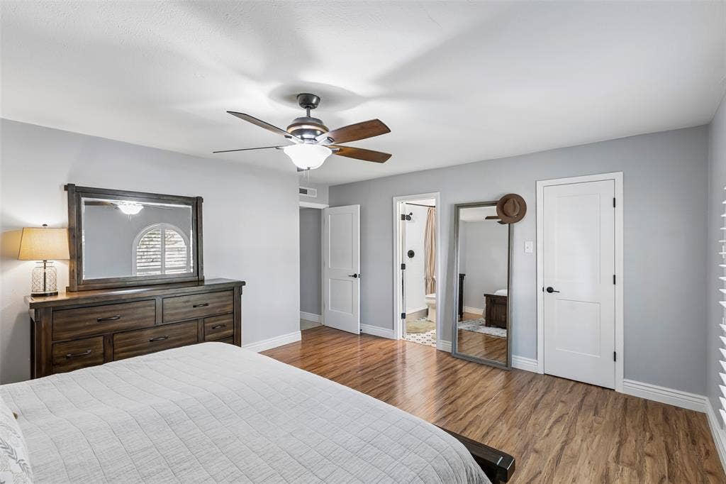 4021 Overdowns Drive, Plano, TX 75023 The primary suite links the bedroom straight through to the bath and walk-in closet — its own self-contained wing.