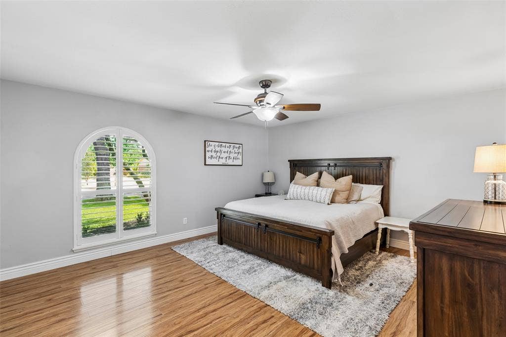 4021 Overdowns Drive, Plano, TX 75023 The primary bedroom's arched, shuttered window brings in soft light without sacrificing privacy.