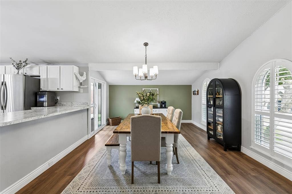 4021 Overdowns Drive, Plano, TX 75023 Arched, shuttered windows dress up the dining room within the home's open floor plan.