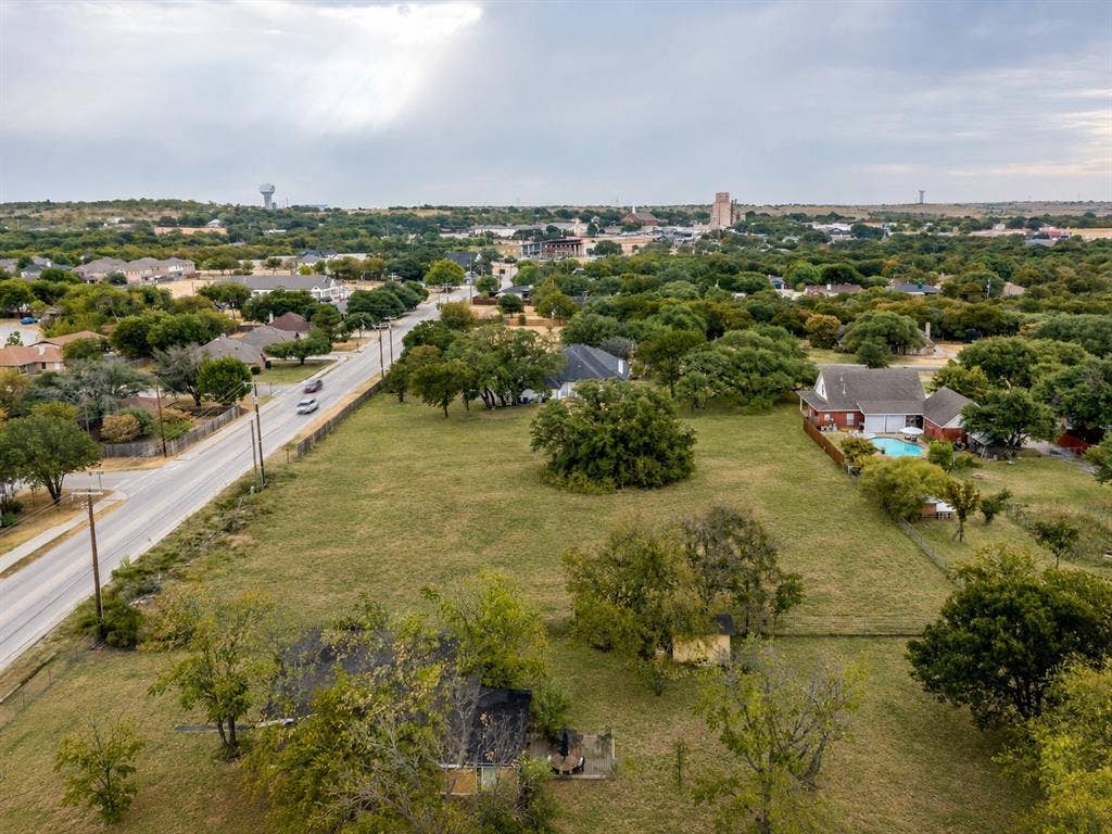 0 Old Annetta Road, Aledo, TX 76008 Expansive grassy lot bordered by mature trees and a paved road