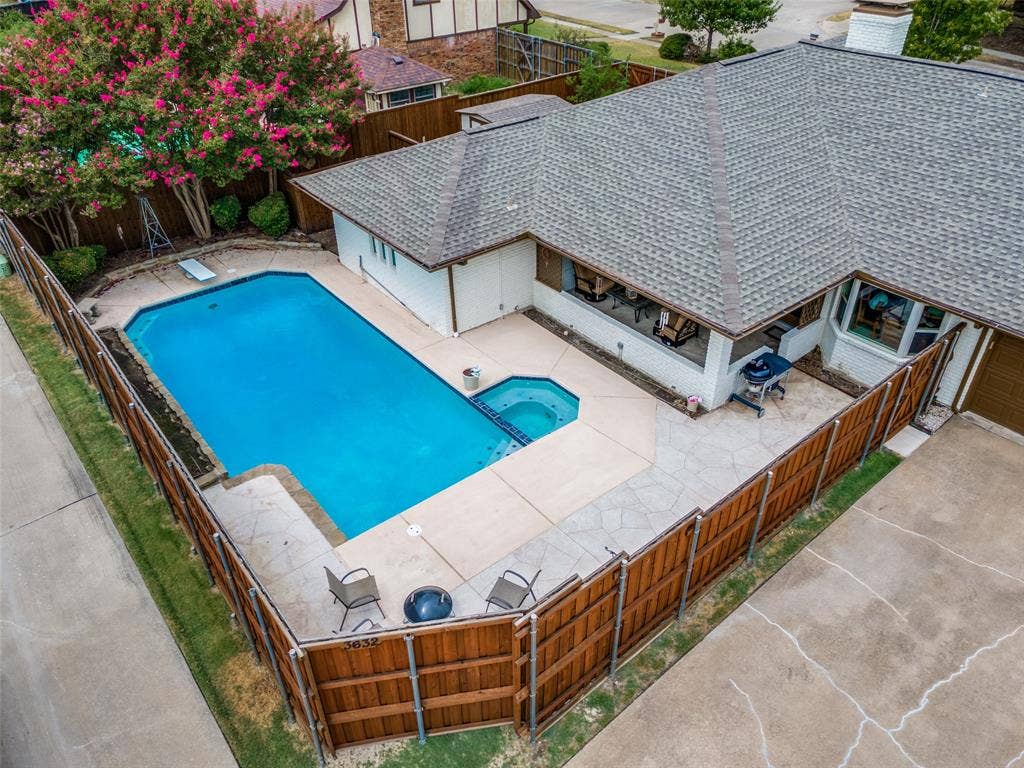 3632 Candelaria Drive, Plano, TX 75023 Private backyard featuring a rectangular pool with an attached spa, wood privacy fencing, and stone paver patio