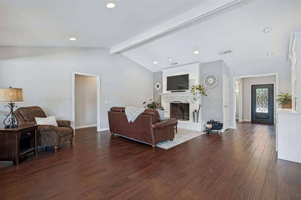 3632 Candelaria Drive, Plano, TX 75023 Vaulted ceiling with recessed lighting, wood-finish flooring, fireplace with a decorative mantel, and an ornate front entry door
