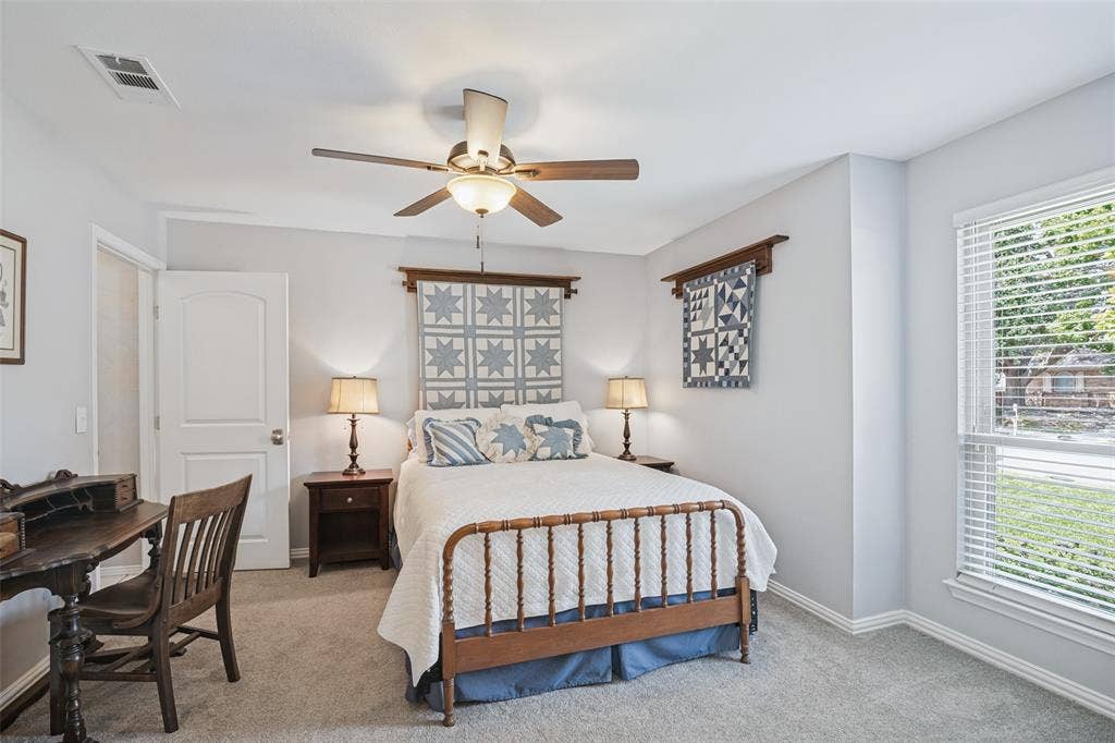 3632 Candelaria Drive, Plano, TX 75023 Carpeted room featuring a ceiling fan with integrated lighting, a white paneled door, and a window with blinds