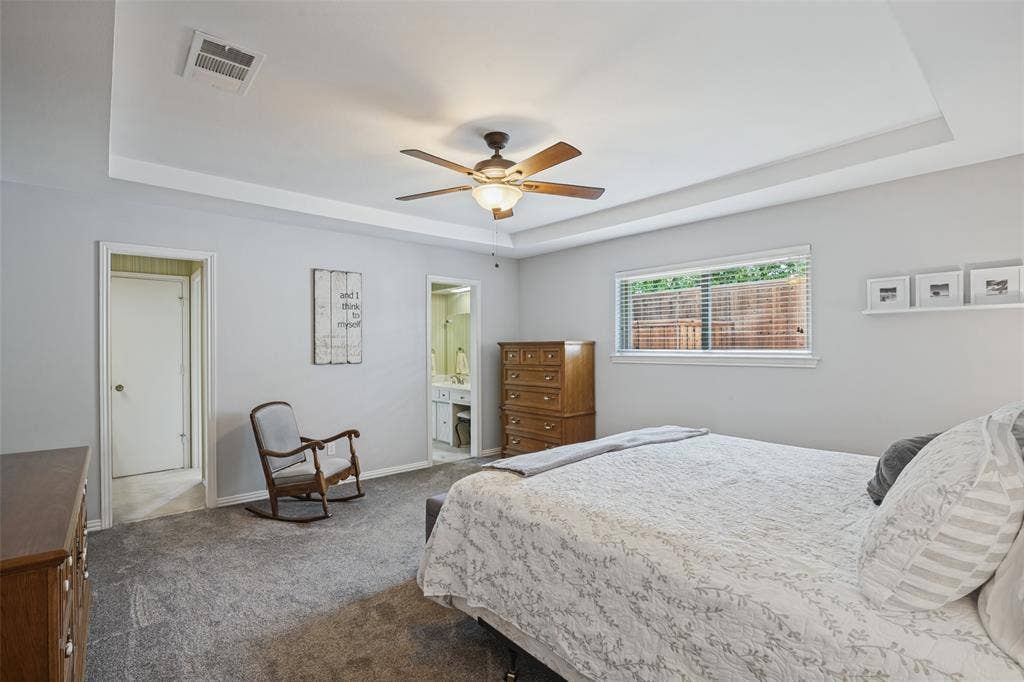 3632 Candelaria Drive, Plano, TX 75023 Tray ceiling with a ceiling fan, light gray wall paint, window with blinds, and gray carpet flooring
